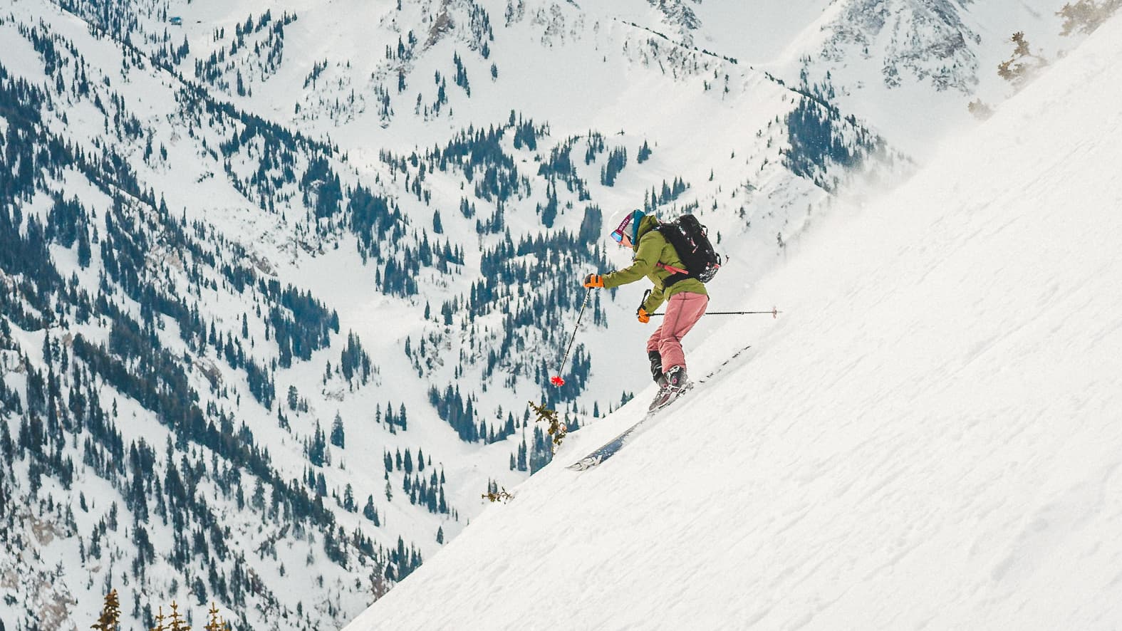 A backcountry skier descending a snowy slope above Park City, Utah